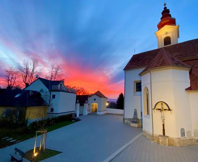 Roter Himmel im Hintergrund vom Kirchplatz @Louis Sekli